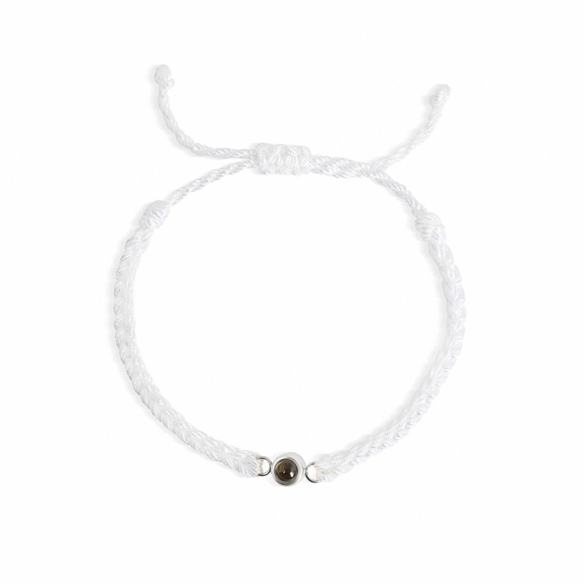 A delicate white braided cord bracelet with an adjustable sliding knot closure and a small central metallic charm, displayed on a clean white background.