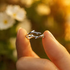 Minimalist sterling silver adjustable branch ring held between fingers
