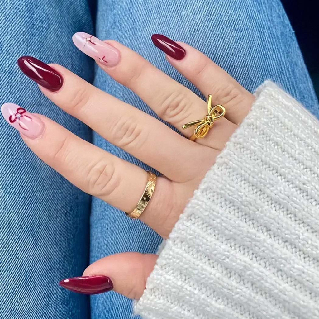 delicate silver bow ring on finger near window light
