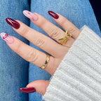 delicate silver bow ring on finger near window light