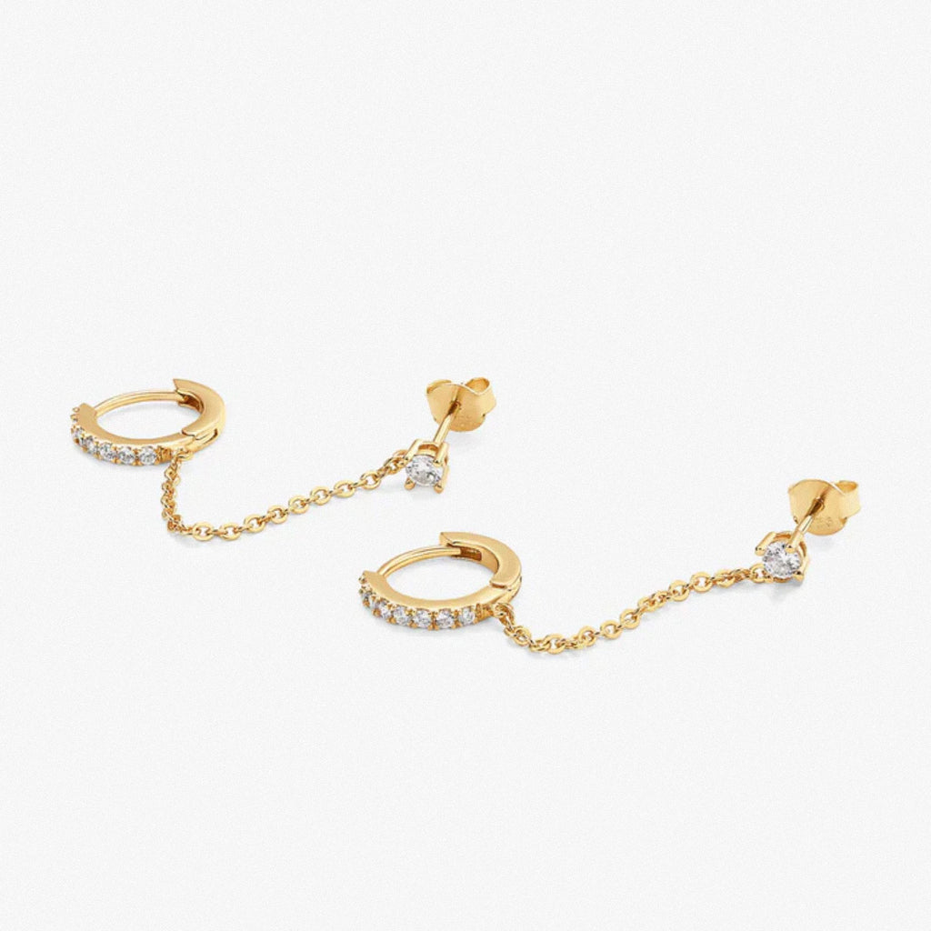 Gold dual chain hoop earrings laid flat