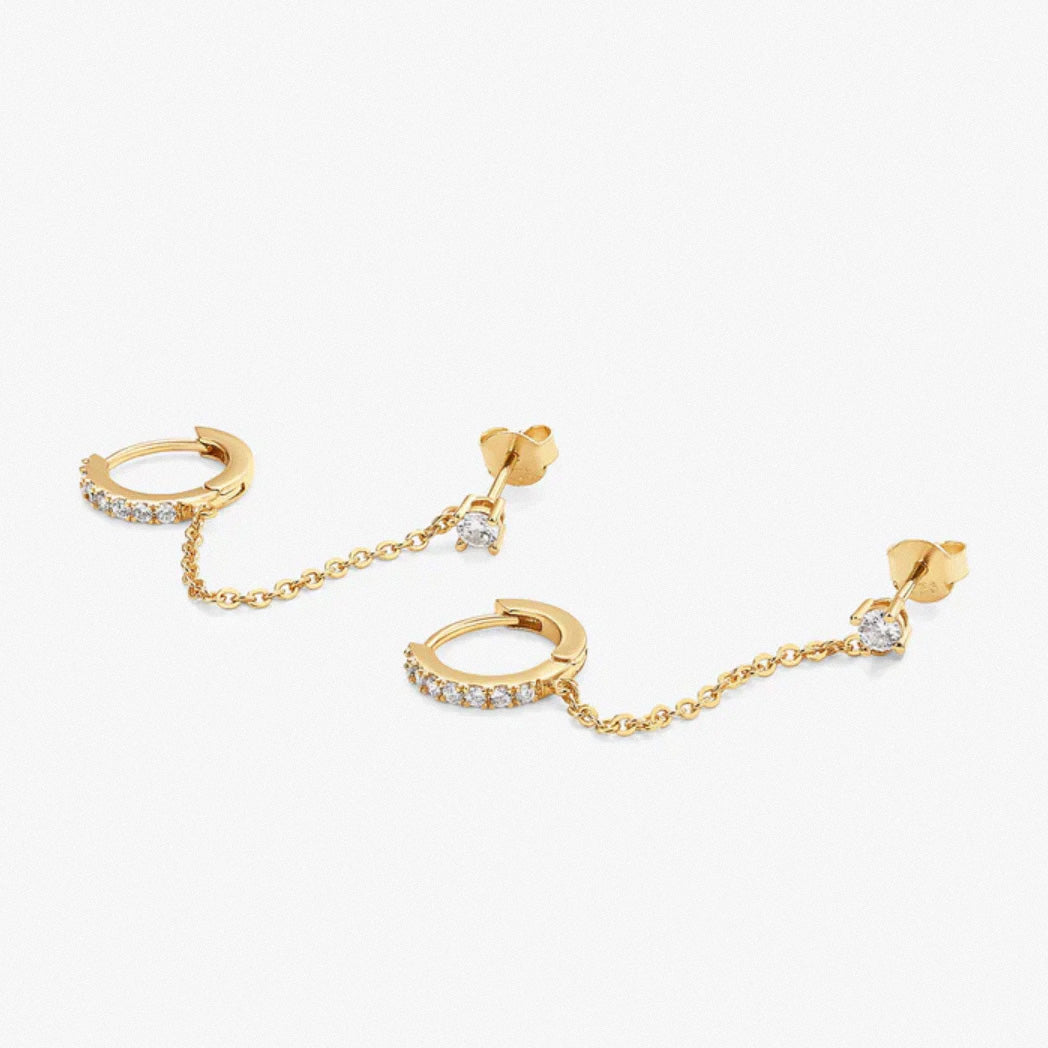 Gold dual chain hoop earrings laid flat