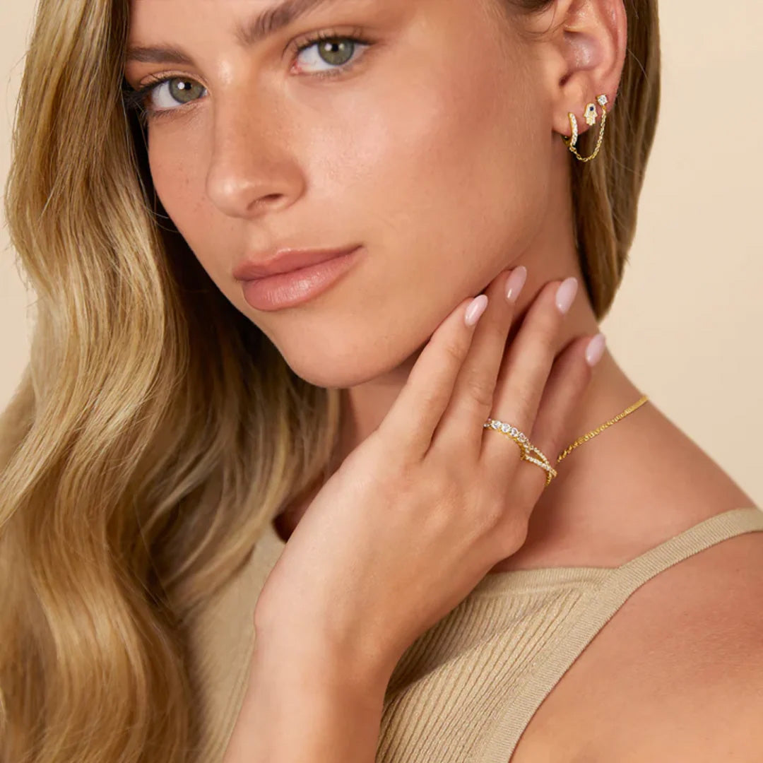 Model wearing gold dual chain hoop earrings