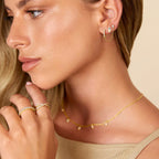 Model wearing gold dual chain hoop earrings – side profile