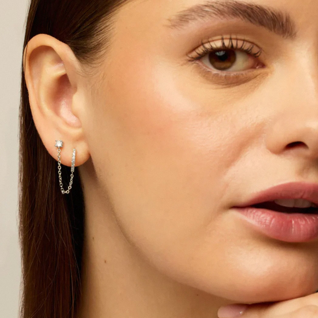 Silver dual chain hoop earrings worn on ear