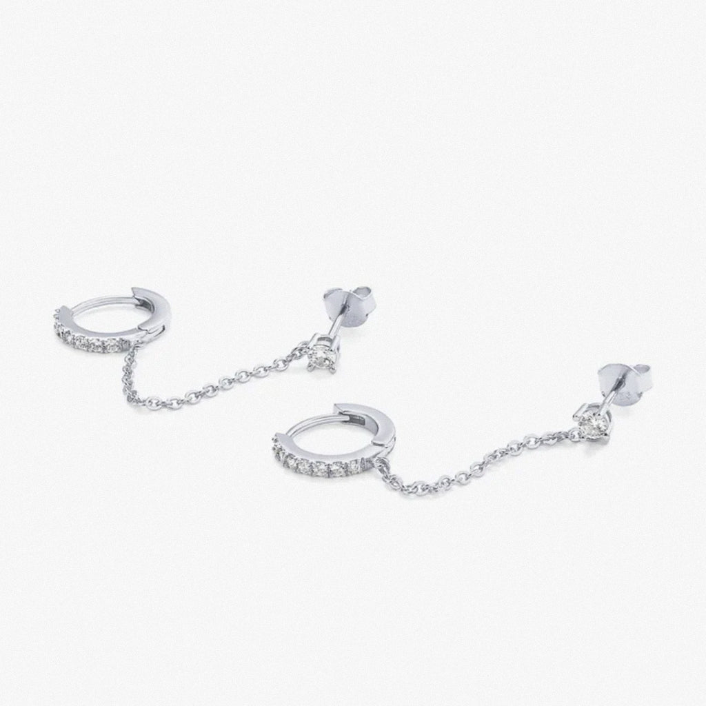 Silver dual chain hoop earrings laid flat