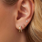 woman wearing gold triple earring stack