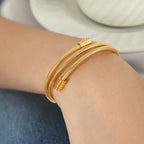 Gold adjustable coil bracelet styled on wrist