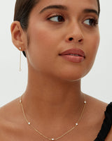Minimalist gold necklace with evenly spaced cubic zirconia stones