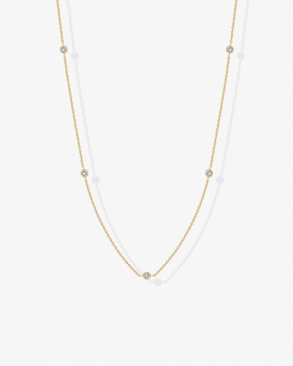 Gold cubic zirconia chain necklace worn on model – delicate minimalist design