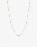 Gold cubic zirconia chain necklace worn on model – delicate minimalist design