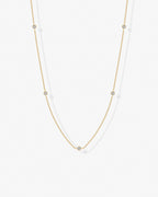 Gold cubic zirconia chain necklace worn on model – delicate minimalist design
