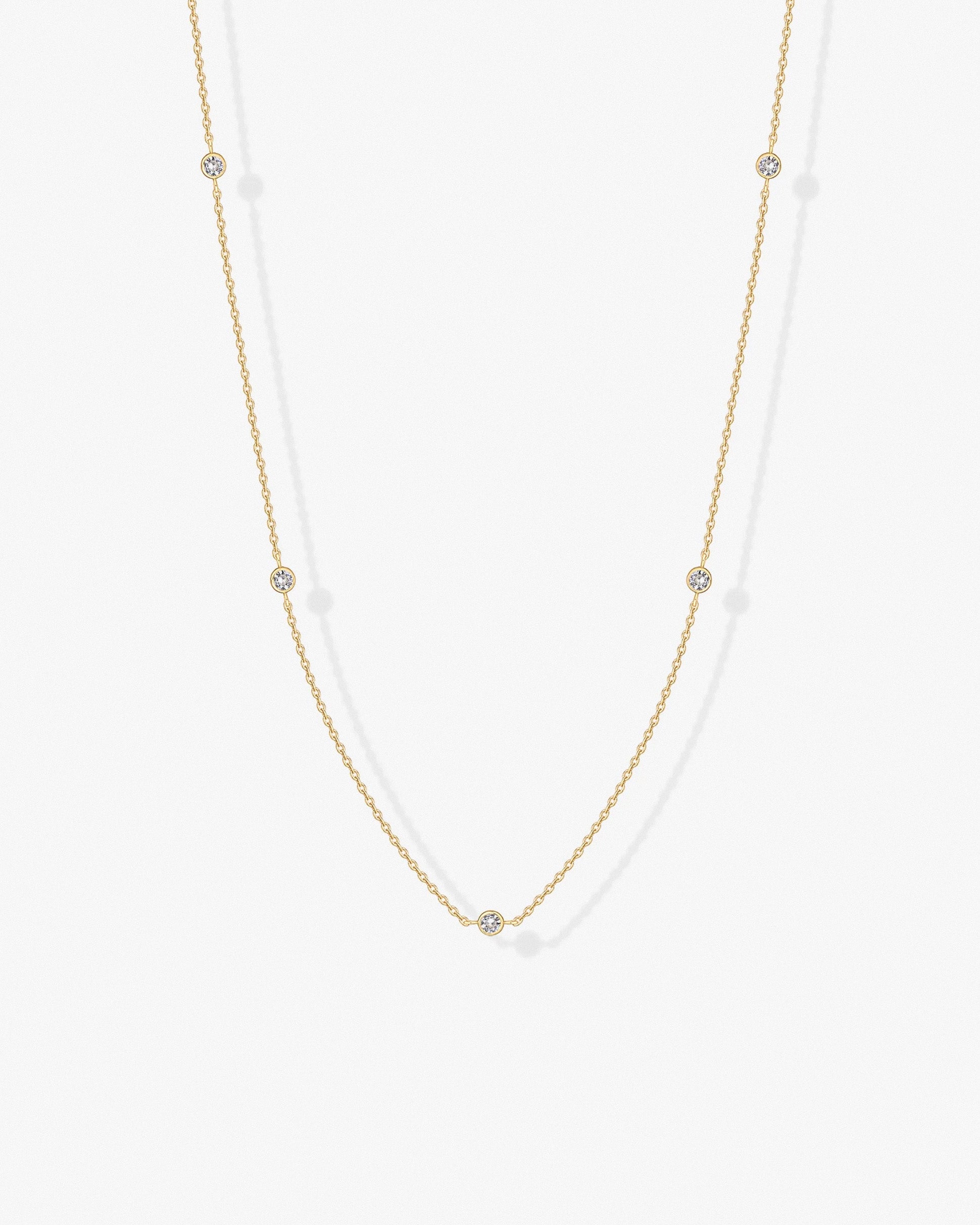 Gold cubic zirconia chain necklace worn on model – delicate minimalist design