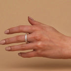 Gold-plated oval zirconia eternity ring seen on extended hand