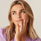 Close-up of model wearing gold-plated oval zirconia eternity ring