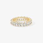 studio photo of gold-plated oval zirconia eternity ring