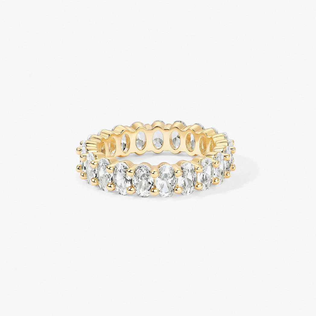 studio photo of gold-plated oval zirconia eternity ring