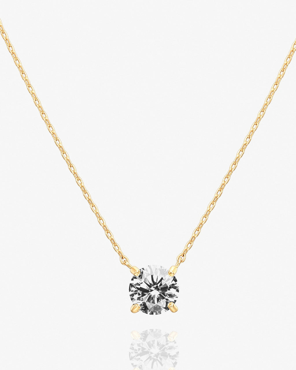 Gold solitaire pendant necklace with cubic zirconia on delicate chain.