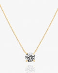Gold solitaire pendant necklace with cubic zirconia on delicate chain.