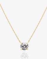 Gold solitaire pendant necklace with cubic zirconia on delicate chain.