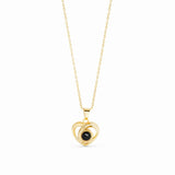 A gold pendant necklace featuring a double-heart design with a central black oval stone, suspended on a delicate gold chain against a plain white background.