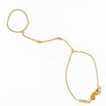 Gold hand chain bracelet with crystal accents displayed flat on white background.