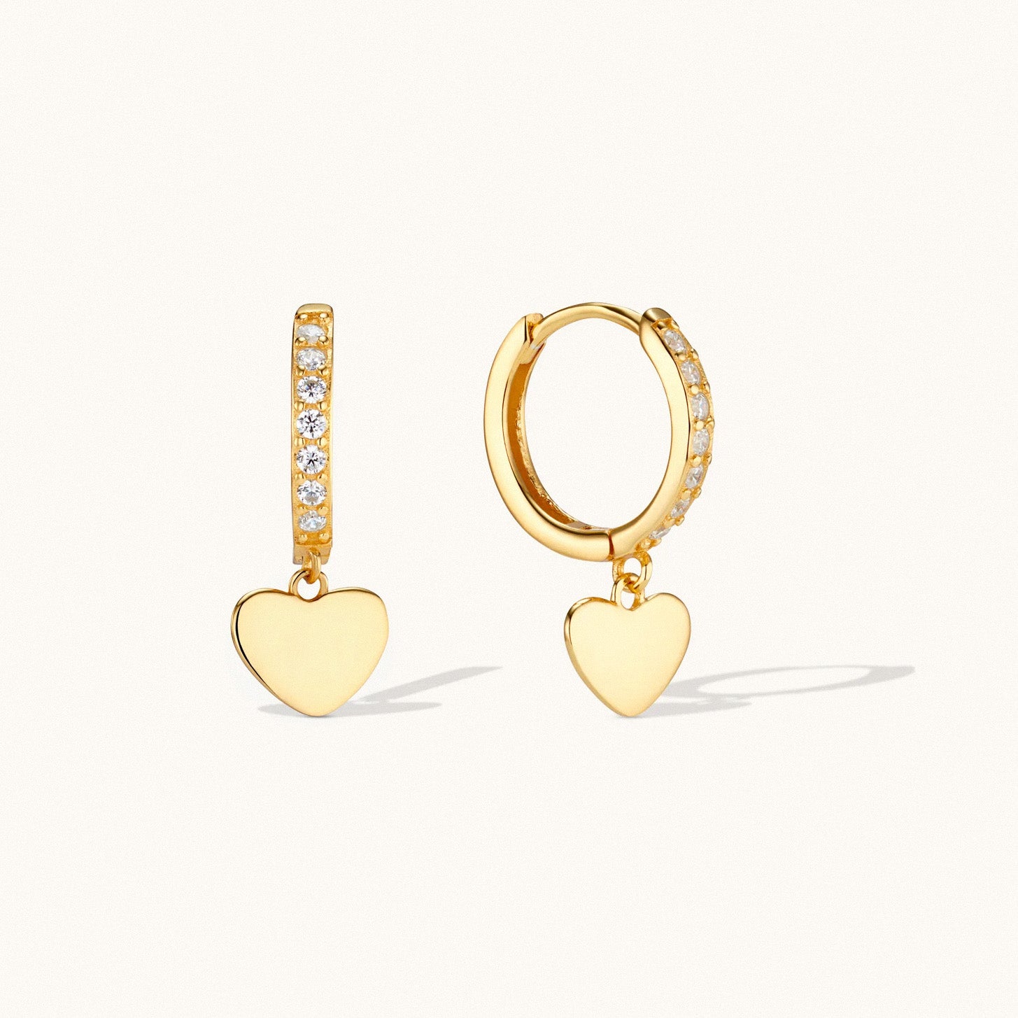 Gold heart dangle huggie earrings with cubic zirconia detailing