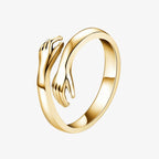 Gold hug ring with open band and hand-shaped ends