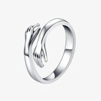 Silver hug ring with polished open-band hand design