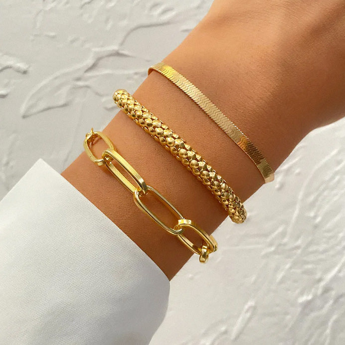 Women’s gold layered bracelet stack worn on wrist