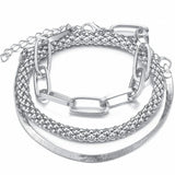 ilver mixed-chain bracelet stack featuring paperclip, rope and snake chains