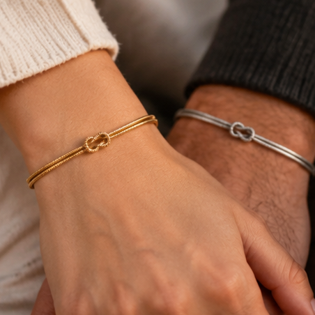 Two wrists side by side wearing gold and silver Love Knot Bracelets