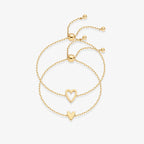 Gold heart duo bracelet set featuring hollow and solid heart charms