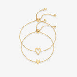 Gold heart duo bracelet set featuring hollow and solid heart charms