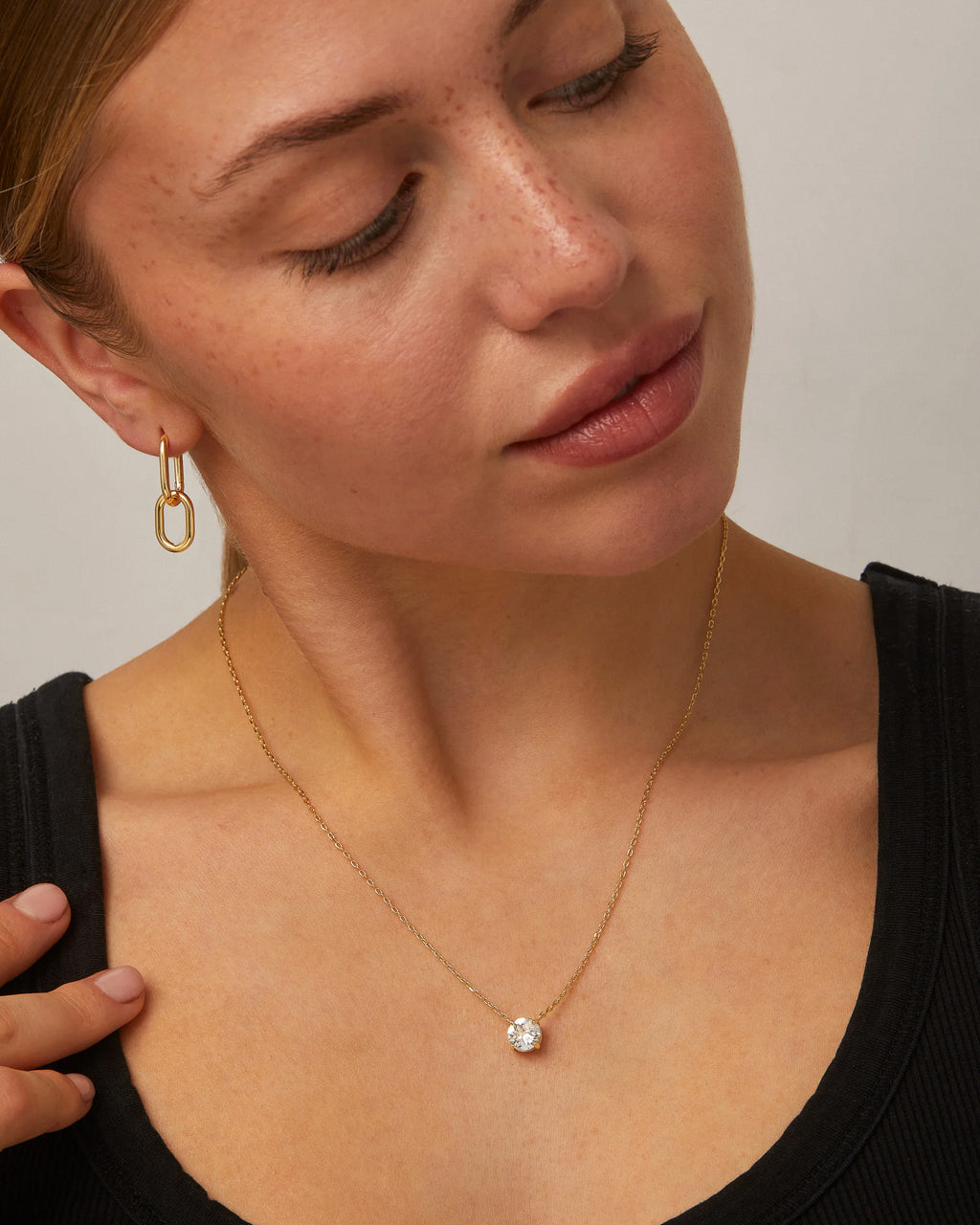 Minimalist gold solitaire necklace with stone shown in detail