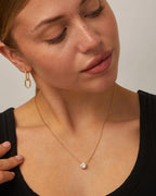 Minimalist gold solitaire necklace with stone shown in detail