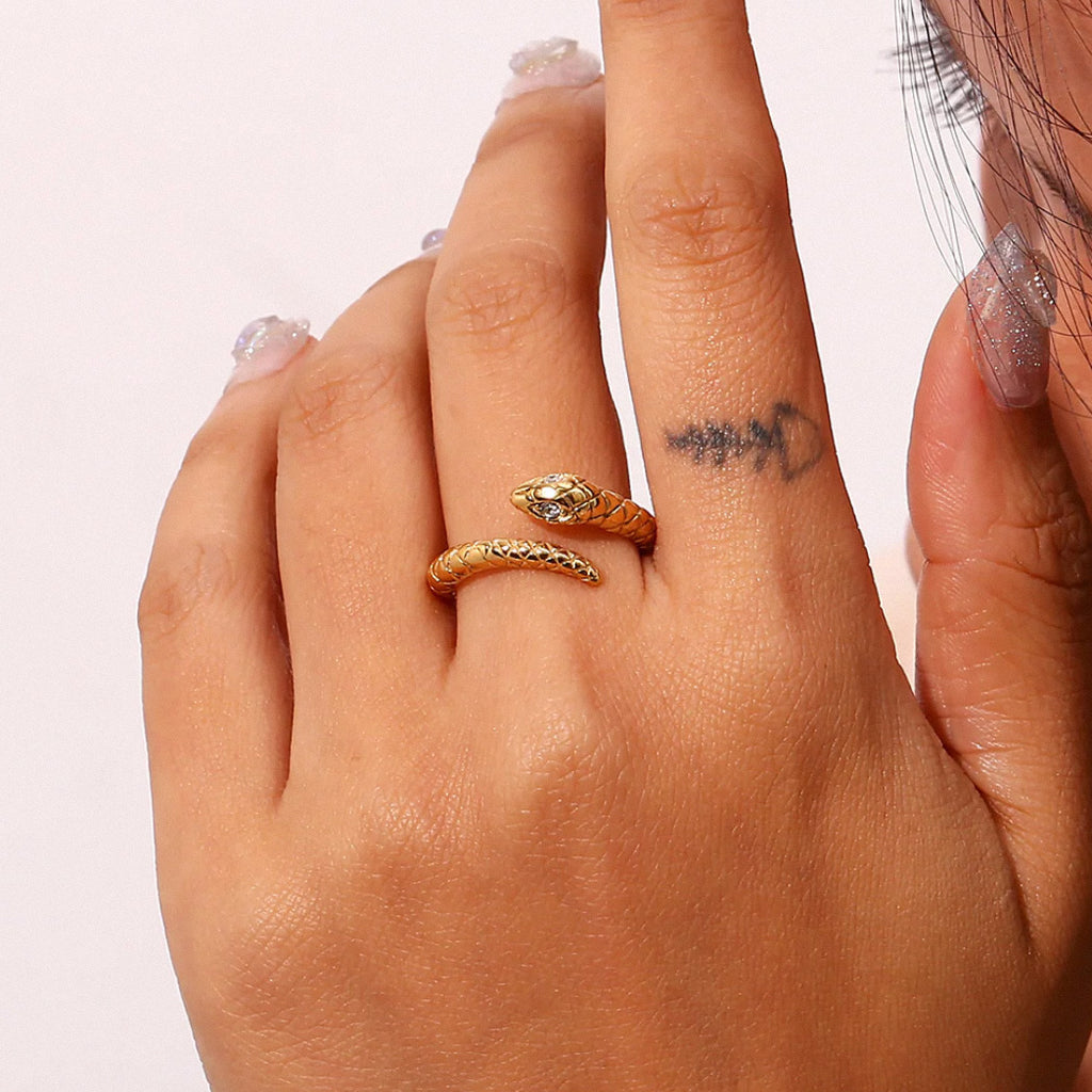 Gold textured snake ring worn on fingers for everyday style