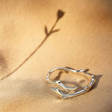 Nature-inspired sterling silver branch ring displayed on fabric