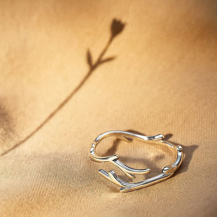 Nature-inspired sterling silver branch ring displayed on fabric