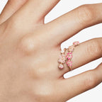 Rose gold pink blossom open ring shown on hand with floral design details