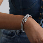 Silver twisted coil bracelet worn with denim outfit