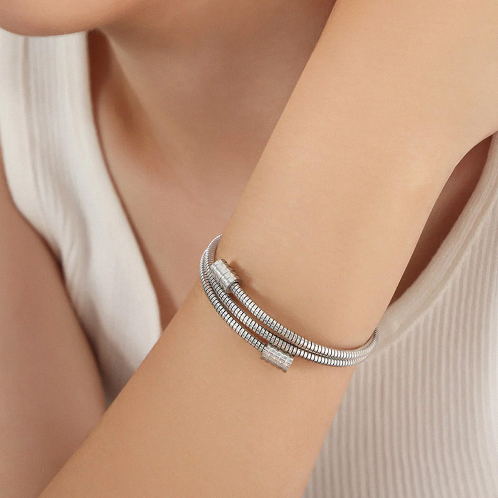 Close-up of silver twisted coil stainless steel bangle bracelet