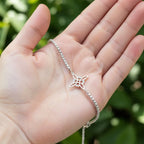 Close-up of sterling silver floral bracelet resting on hand