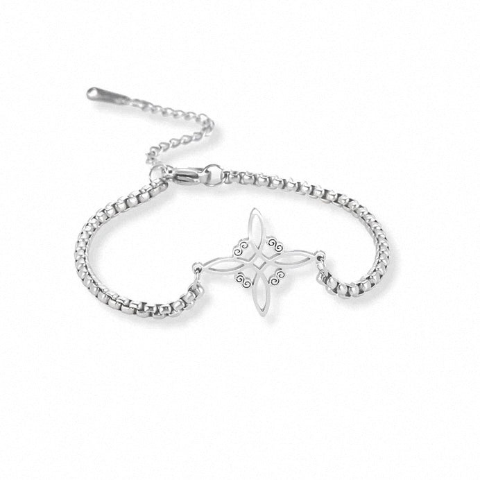 Sterling silver floral charm bracelet on wrist – minimalist cubic zirconia design
