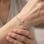 Sterling silver floral charm bracelet product shot with cubic zirconia accents