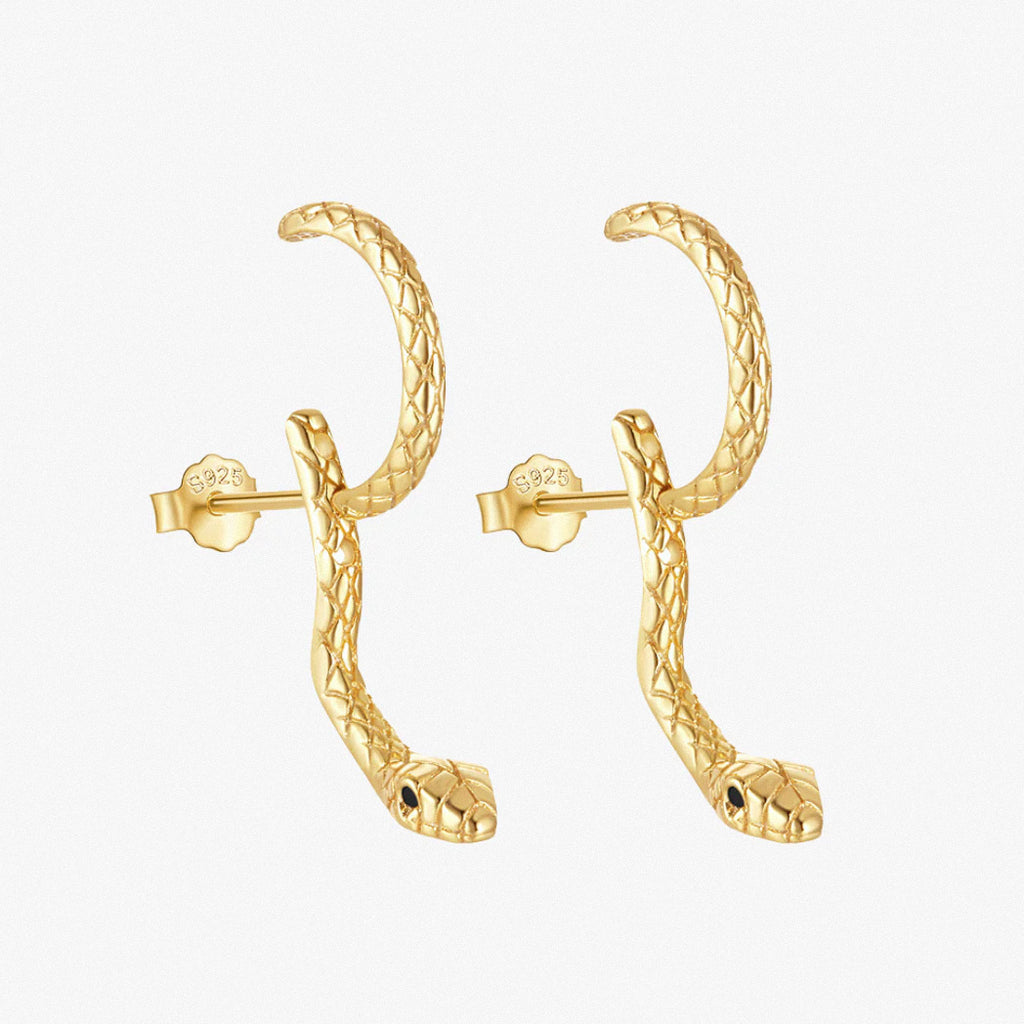 Gold snake hoop earrings on white background