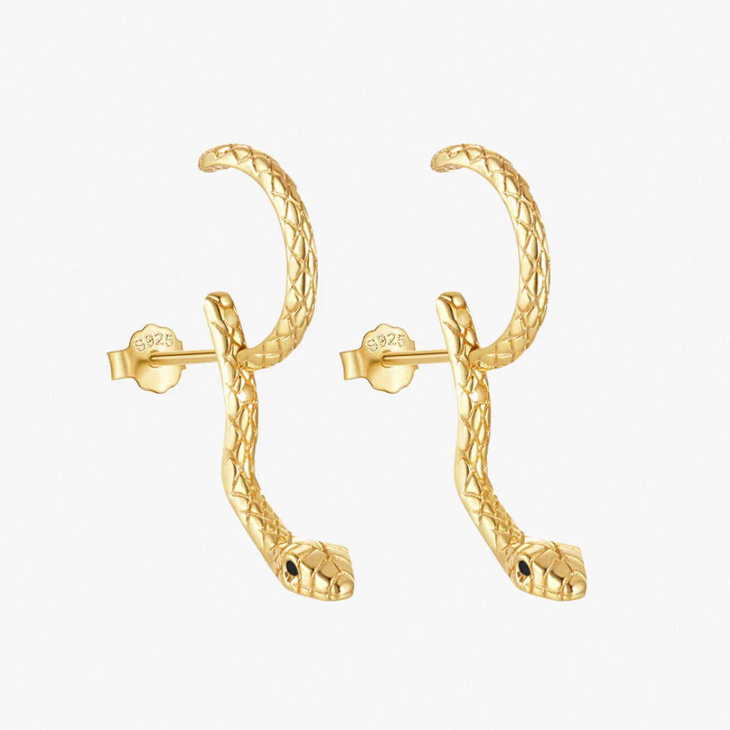 Gold snake hoop earrings on white background