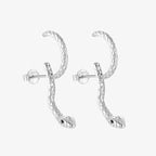 Silver snake hoop earrings on white background
