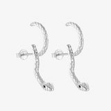 Silver snake hoop earrings on white background