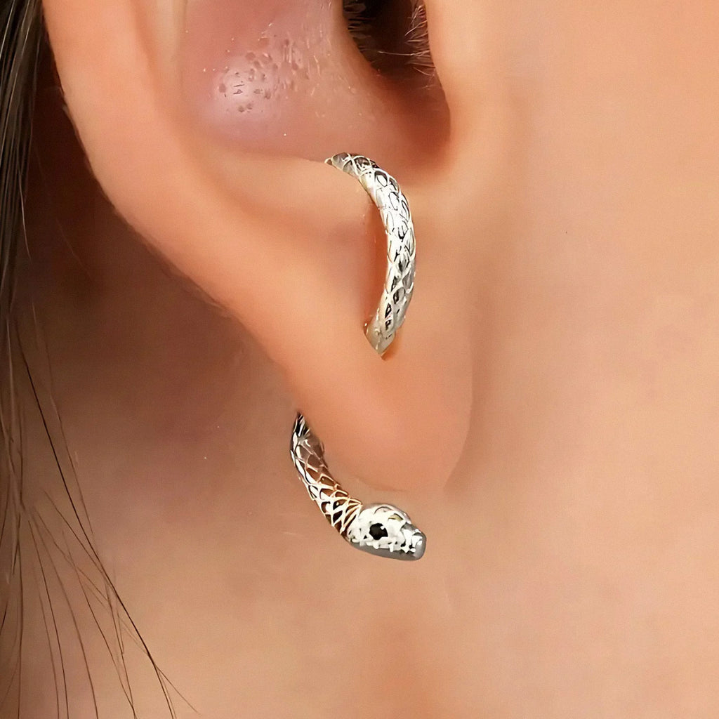 Silver snake hoop earring worn on ear